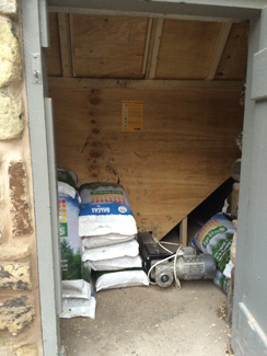 Pellet store with sacks of pellets and a pellet hopper