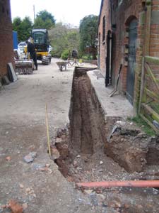A trench alongside a property for laying a ground loop collector pipe