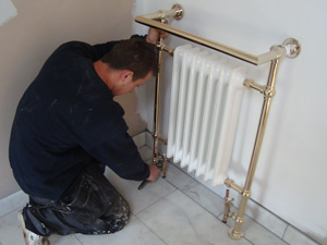 A radiator / heated towel rail installation in a bathroom